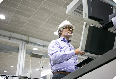 Engineer inspecting industrial equipment in a production facility