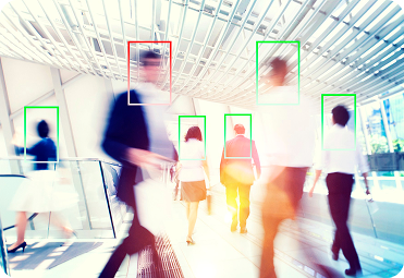 People moving through a bright workplace with digital face detection overlays